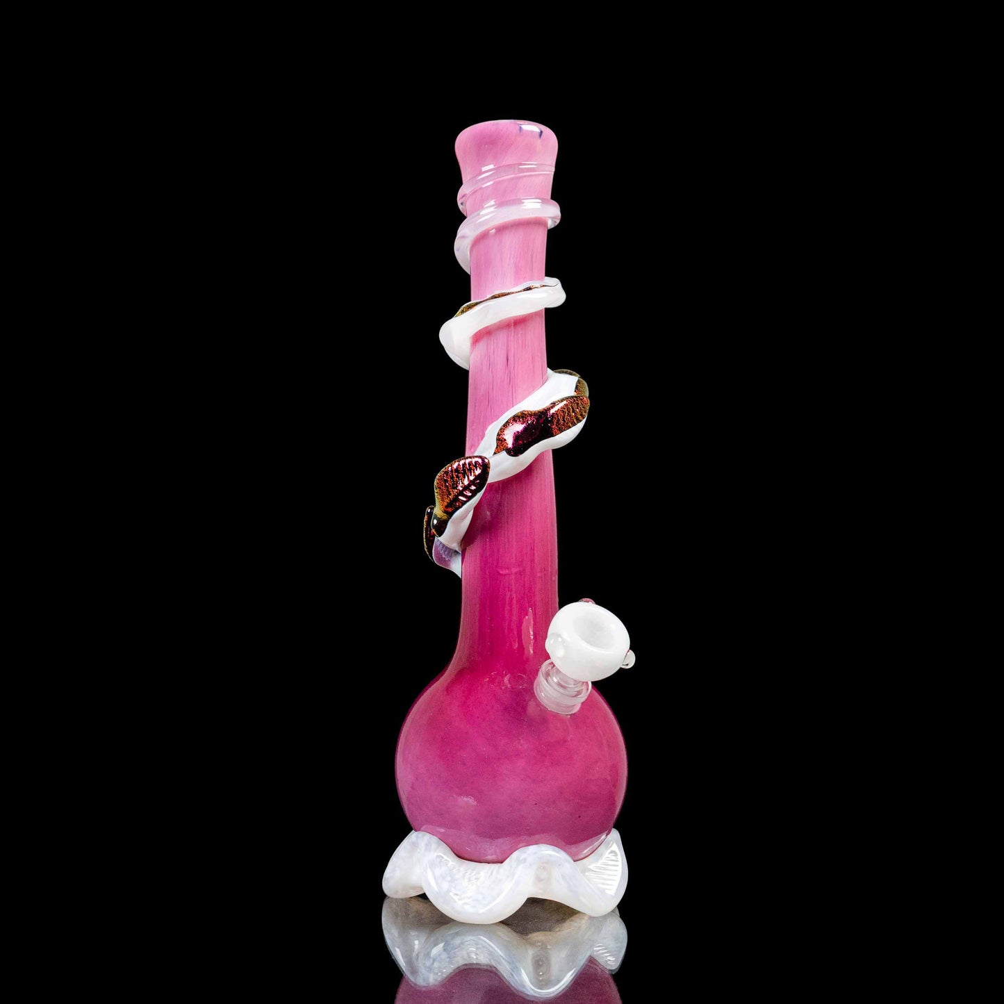 This image features a striking medium-sized glass piece, predominantly in a vivid hot pink color, with white and gold accents. The piece includes a bowl and a downstem, showcasing a smooth, glossy finish.